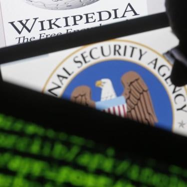 A man is seen near cyber code and the U.S. National Security Agency logo in this photo illustration taken in Sarajevo March 11, 2015.