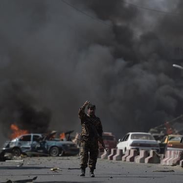 An Afghan security force member stands at the site of a car bomb attack in Kabul on May 31, 2017. At least 40 people were killed or wounded on May 31 as a massive blast ripped through Kabul's diplomatic quarter, shattering the morning rush hour and bringi
