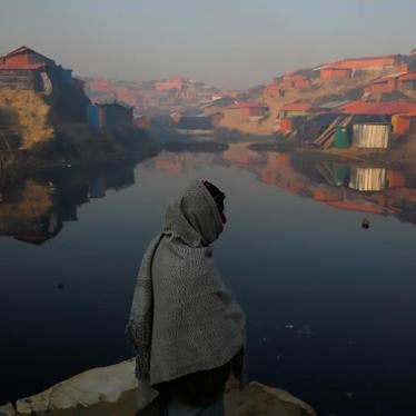 A Rohingya refugee stands next to a pond in the early morning at the Balukhali refugee camp near Cox's Bazar, Bangladesh December 26, 2017. REUTERS/Marko Djurica TPX IMAGES OF THE DAY