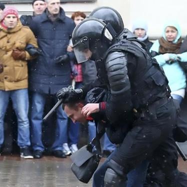Riot police detain a man during a rally in Minsk on March 25.