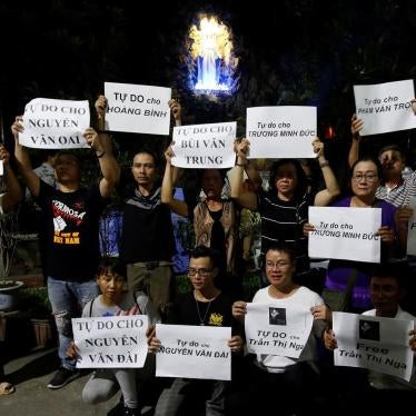 Supporters hold signs with names of jailed activists at an event held to call for their release in Hanoi, Vietnam, August 27, 2017.