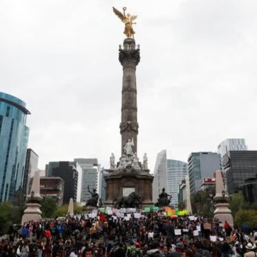 Demonstrators hold up posters in a protest march demanding to know the whereabout of high school student Marco Antonio Sanchez, who disappeared several days ago after a dispute with police officers, according to local media, at the Angel of Independence i