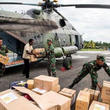 Indonesian soldiers along with a local resident unload food and medical aid in Ewer, Asmat District, in the remote region of Papua, Indonesia January 29, 2018 in this photo taken by Antara Foto.