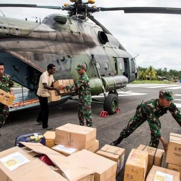 Indonesian soldiers along with a local resident unload food and medical aid in Ewer, Asmat District, in the remote region of Papua, Indonesia January 29, 2018 in this photo taken by Antara Foto.
