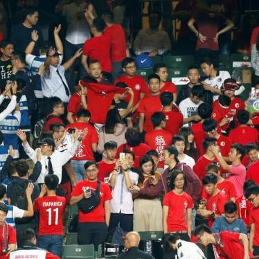 Security guards wave to urge Hong Kong fans stop booing and turning their backs during Chinese national anthem, at the Asian Cup preliminary match between Hong Kong and Lebanon in Hong Kong, China November 14, 2017.