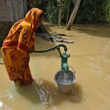A woman fetches water from a partially submerged hand pump in a flood-affected village in Sonitpur district in the northeastern state of Assam, India, September 11, 2017.