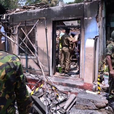 Sri Lanka's Special Task Force and Police officers stand guard near a burnt house after a clash between two communities in Digana, central district of Kandy, March 6, 2018.