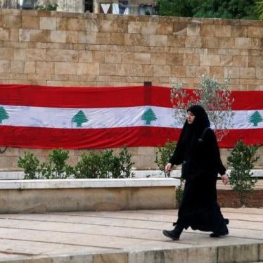 A woman walks past a Lebanese flag in Beirut, Lebanon, November 21, 2017.