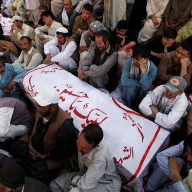 Shi'ite Muslim men from Pakistan's ethnic Hazara minority mourn around the coffins of their relatives, who were killed in a shooting attack, in Quetta, Pakistan October 9, 2017.