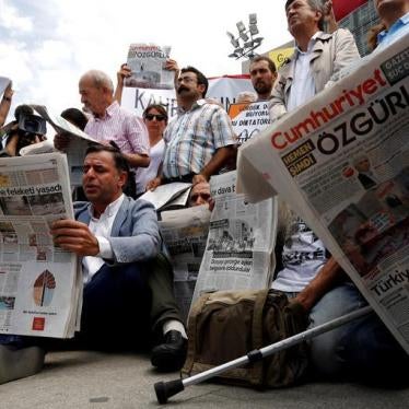 Press freedom activists read opposition newspaper Cumhuriyet during a demonstration in solidarity with the jailed members of the newspaper outside a courthouse, in Istanbul, Turkey, July 28, 2017. 