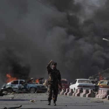 A member of the Afghan security forces stands at the site of a truck bomb attack in Kabul, May 31, 2017.