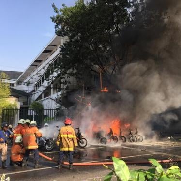 Firefighters try to extinguish a blaze following a blast at the Pentecost Church Central Surabaya (GPPS), in Surabaya, East Java, Indonesia May 13, 2018