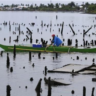A fisherman paddles his banca amidst ruins of house stilts destroyed by Typhoon Haiyan on a coastal village in Tacloban city in central Philippines November 2, 2015.