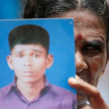 A woman holds up an image of her family member who disappeared during the civil war with the Liberation Tigers of Tamil Eelam (LTTE) at a silent protest to commemorate thethe International Day of the Victims of Enforced Disappearances in Colombo, Sri Lank