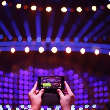 A spectator takes a photo on a mobile phone before the Semi-Final 2 for Eurovision Song Contest 2018 at the Altice Arena hall in Lisbon, Portugal.