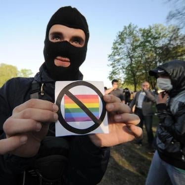 An anti-gay rights activist shows a badge during a flash mob organized by gay rights protesters in St. Petersburg May 17, 2012.