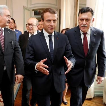 French President Emmanuel Macron walks with Libyan Prime Minister Fayez al-Sarraj and General Khalifa Haftar, commander in the Libyan National Army (LNA), before a meeting for talks over a political deal to help end Libya’s crisis in La Celle-Saint-Cloud 