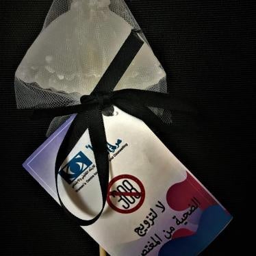 Photo showing a white dress symbolizing a bride produced by the Women’s Centre for Legal Aid and Counselling as part of their campaign to repeal article 308 which had allowed rapists to escape prosecution if they married their victims. The message in Arab