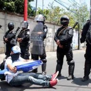 A demonstrator sits in front of a line of riot police during a protest in Managua, Nicaragua May 2, 2018. 