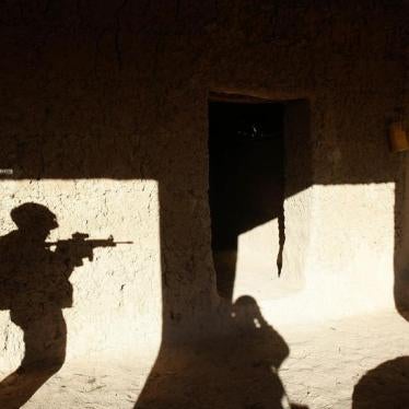 A US soldier searches a house in a village in Baluchi pass in Uruzgan province, November 1, 2004.