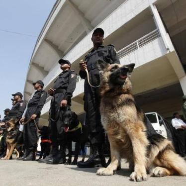Members of Rapid Action Battalion (RAB) stand guard with dogs in Dhaka, Bangladesh, February 12, 2011.