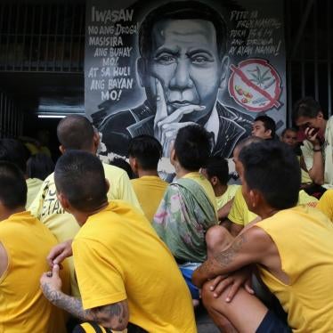 Detainees sit next to an anti-drug mural of Philippines President Rodrigo Duterte inside the Manila City Jail, October 16, 2017.