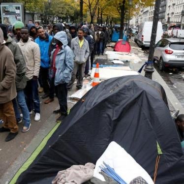 Migrants queue for a free meal distributed by the Adventist Development and Relief Agency International (ADRA) humanitarian agency on a street near Stalingrad metro station in Paris, France, October 28, 2016