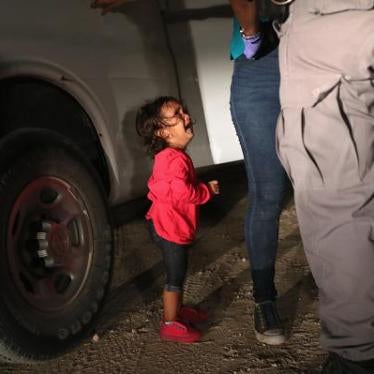 A two-year-old Honduran asylum seeker cries as her mother is searched and detained near the US-Mexico border on June 12, 2018, in McAllen, Texas. Customs and Border Protection (CBP) is executing the Trump administration's 'zero tolerance' policy towards u