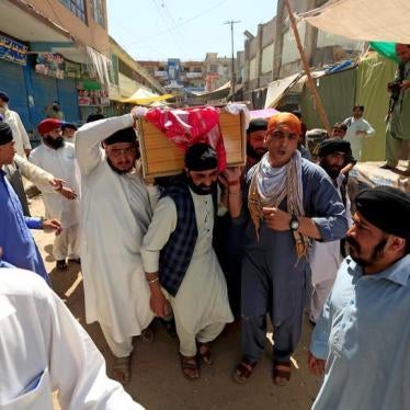 Afghan Sikh men carry the coffin of a bombing victim in Jalalabad, Afghanistan, July 2, 2018.