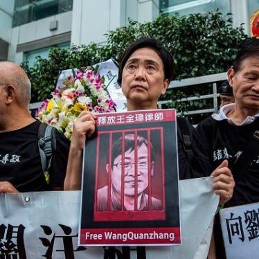 Caption: Hong Kong former lawmaker Emily Lau holds a sign of detained Chinese human rights lawyer Wang Quanzhang at a rally outside the Chinese Liaison Office in Hong Kong on April 5, 2018. © 2018 Getty Images