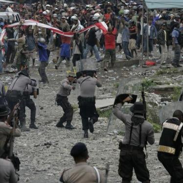 Police fire warning shots in the air to disperse protesters during a demonstration in Timika of Indonesia's Papua province October 10, 2011.
