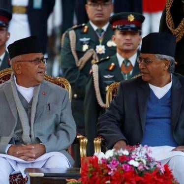 Newly elected Nepalese Prime Minister Khadga Prasad Sharma Oli, also known as K.P. Oli (L), speaks with the outgoing Prime Minister Sher Bahadur Deuba, after administrating the oath of office at the presidential building "Shital Niwas" in Kathmandu, Nepal