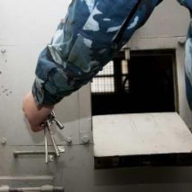 A guard in a solitary confinement block at an unidentified prison in Uzbekistan. Prisoners in solitary confinement in Uzbekistan’s prisons experience cramped cells without bedding—some in total darkness, others with permanent bright lights
