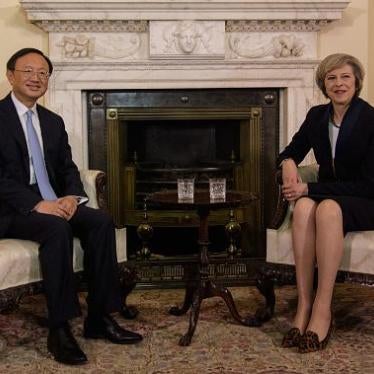 British Prime Minister Theresa May (R) sits with Chinese State Councillor Yang Jiechi (L) for a meeting at 10 Downing Street in London on December 20, 2016.