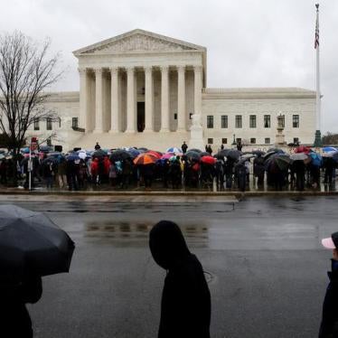 Protesters for and against abortion rights huddle under umbrellas as they rally in groups outside while the U.S. Supreme Court hears oral arguments in the abortion case National Institute of Family and Life Advocates (NIFLA) v. Becerra, in Washington, U.S