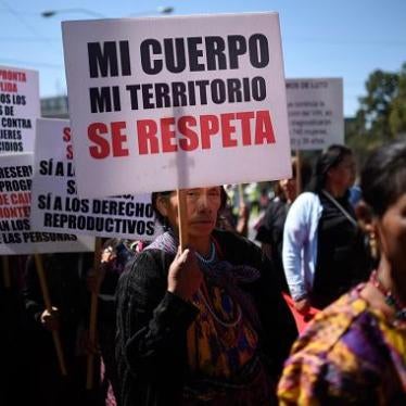 An indigenous woman holds a placard reading 'My Body My Territory Is to be Respected' as she demonstrates on International Women's Day in Guatemala City on March 8, 2018. 