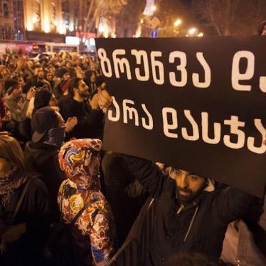 A sign which reads “Care instead of Punishment” is held aloft at a protest rally calling for decriminalization of personal drug use, Tbilisi, Georgia, December 10, 2016. 