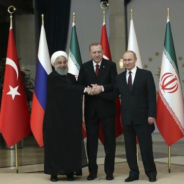 Iran's President Hassan Rouhani, Russia's President Vladimir Putin, and Turkey's President Recep Tayyip Erdogan lock hands during a group photo in Ankara, Turkey, Wednesday, April 4, 2018. © 2018 Tolga Bozoglu/Pool Photo via AP