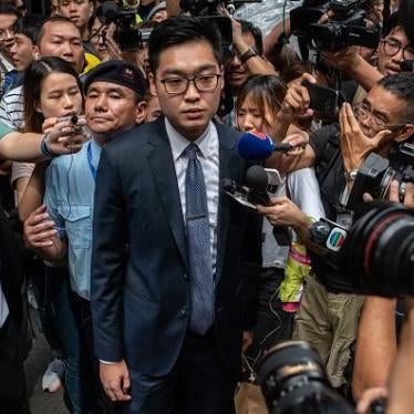 Andy Chan (C), founder of the Hong Kong National Party, is surrounded by members of the media as he leaves the Foreign Correspondents' Club (FCC) in Hong Kong on August 14, 2018. 