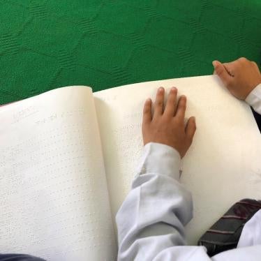 A student who is blind using a braille textbook in a mainstream classroom, public school, Kathmandu, Nepal. May 9, 2018 Human Rights Watch.