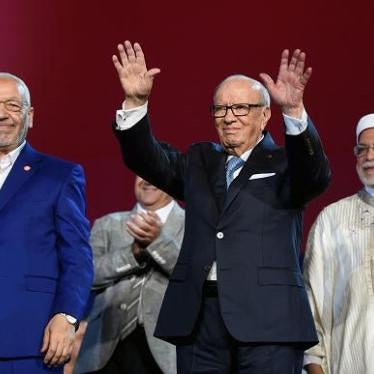 Tunisian president Beji Caid Essebsi, Islamist Ennahdha Party leader Rached Ghannouchi, and Ennahdha Party vice-president Abdelfattah Mourou wave to the crowd on May 20, 2016 at the opening of Ennahdha's three-day congress in Tunis. ©2016 Fethi Belaid/AFP