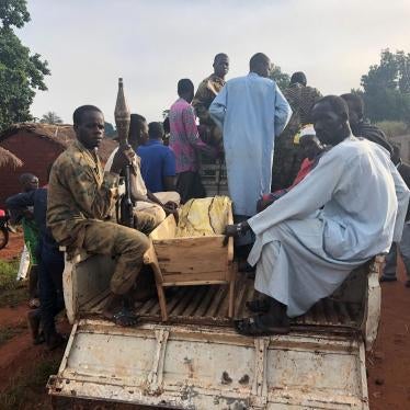 Civilians and Seleka fighters from the Popular Front for the Renaissance in the Central African Republic (Front Populaire pour la Renaissance de la Centrafrique, FPRC) move the body of Mariam Hussein for burial on September 22, 2018. Hussein was killed t