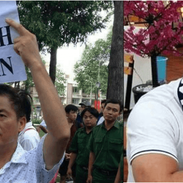 Photos of Nguyen Van Duc Do (right), wearing a human rights hat, and Luu Van Vinh (left), at a pro-environment protest carrying a sign that reads, "Return Clean Sea to the People".  