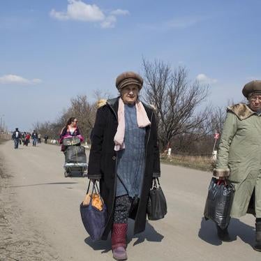 People walking across the crossing point at Stanitsa Luhanska. 