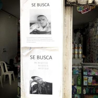 Posters requesting information on the whereabouts of two disappeared men on the wall of a store in the city of Tumaco, August 9, 2018. 