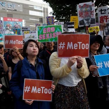 Protesters hold placards during a rally against harassment at Shinjuku shopping and amusement district in Tokyo, Japan, April 28, 2018
