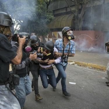 Journalists assist fellow reporter Gregory Jaimes who was injured after being shot by police officers near the La Carlota airbase during clashes with anti-government protestors in Caracas, Venezuela, Wednesday, May 1, 2019.
