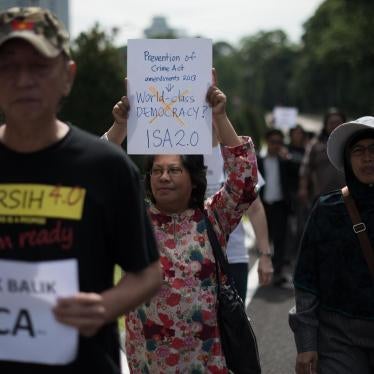 Activists hold placards during a protest against an amendment to a 1959 crime prevention act that would give police a stronger hand, outside the parliament house in Kuala Lumpur on September 30, 2013.