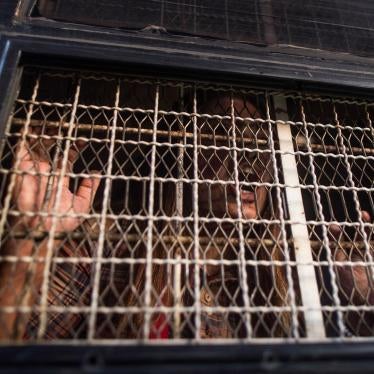 A demonstrator shouts from inside a prison van after being detained by Myanmar police during an anti-war protest in Yangon, May 12, 2018. 