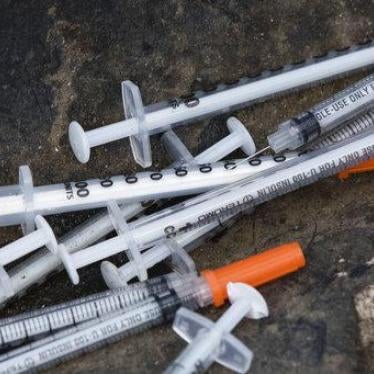 Discarded syringes in an open-air heroin market that has thrived for decades, slated for cleanup along train tracks a few miles outside the heart of Philadelphia